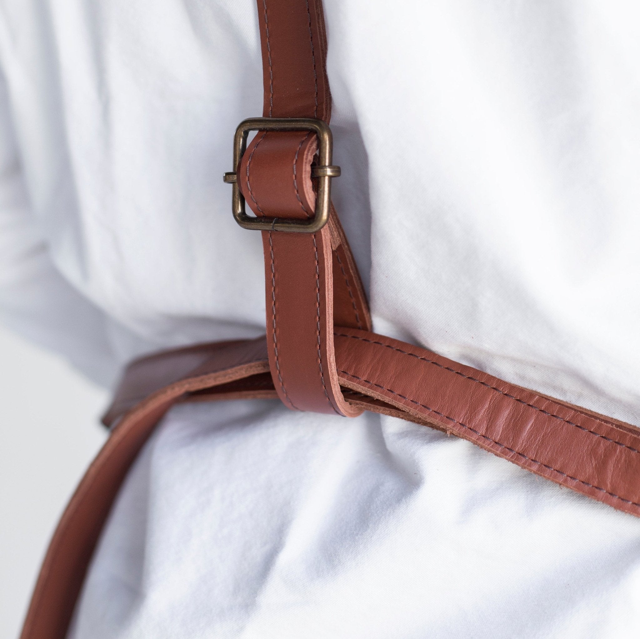 Canvas and leather apron with adjustable straps, chest pocket, and tool loops — durable stylish for grilling, crafts, or work