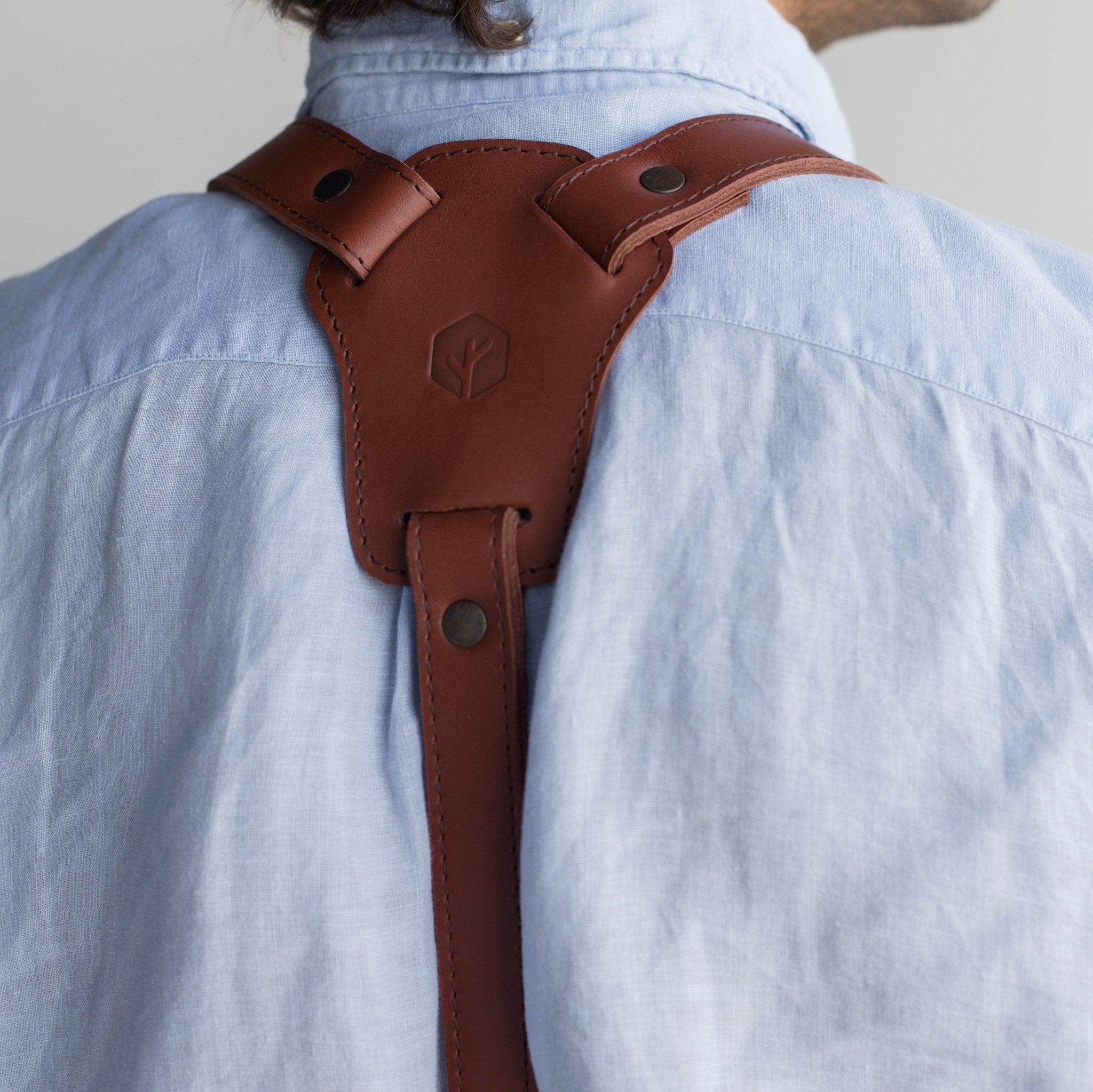 Full leather apron, adjustable straps, front chest pocket, tool loops, and rich texture, ideal for grilling, crafts, shop use