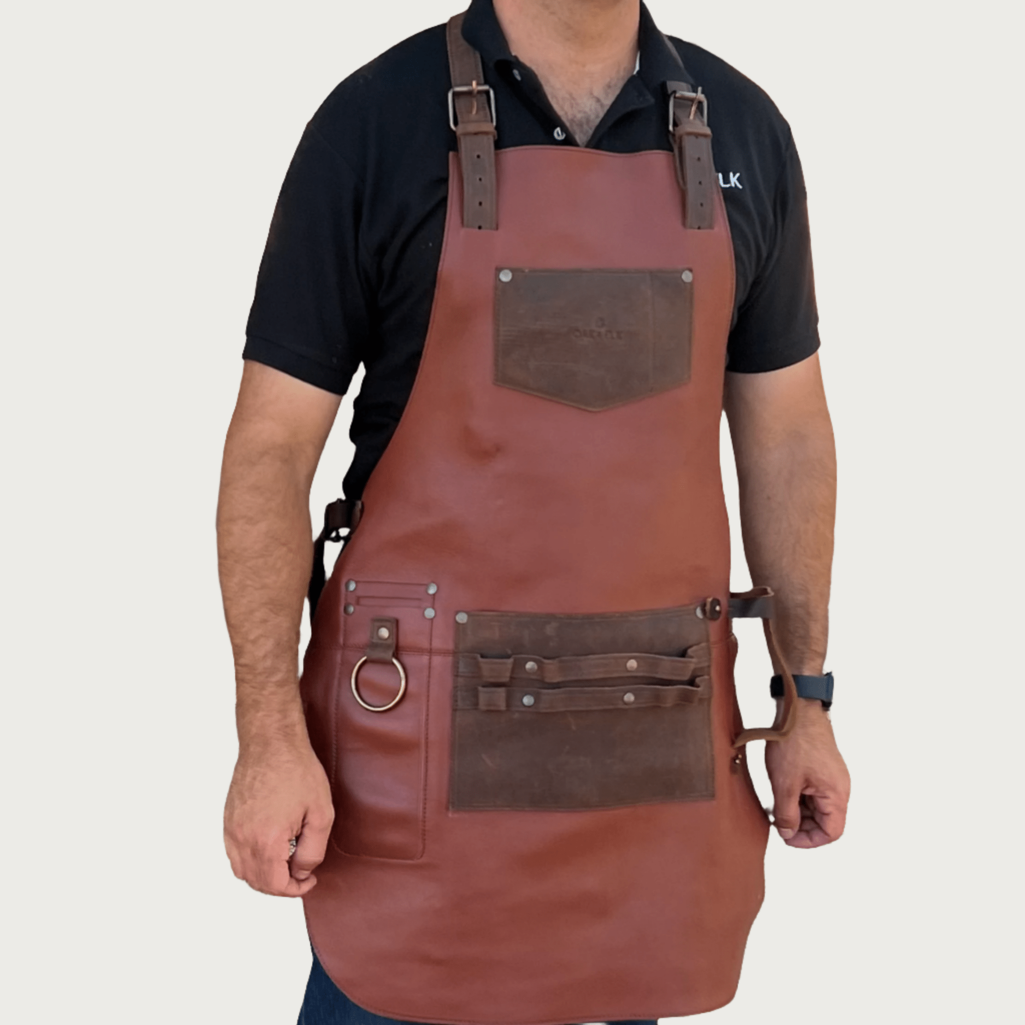 Full leather apron, adjustable straps, front chest pocket, tool loops, and rich texture, ideal for grilling, crafts, shop use