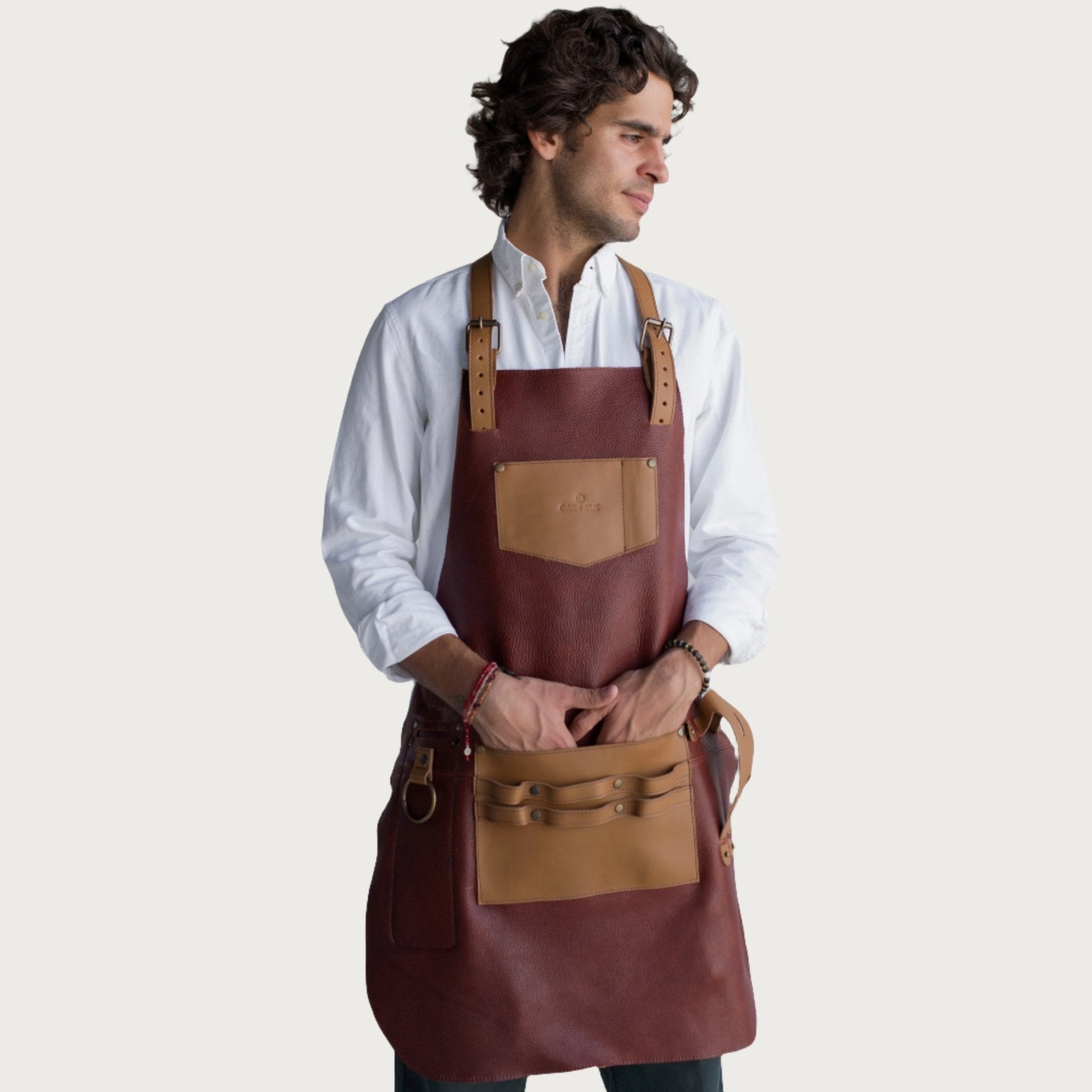 Full leather apron, adjustable straps, front chest pocket, tool loops, and rich texture, ideal for grilling, crafts, shop use