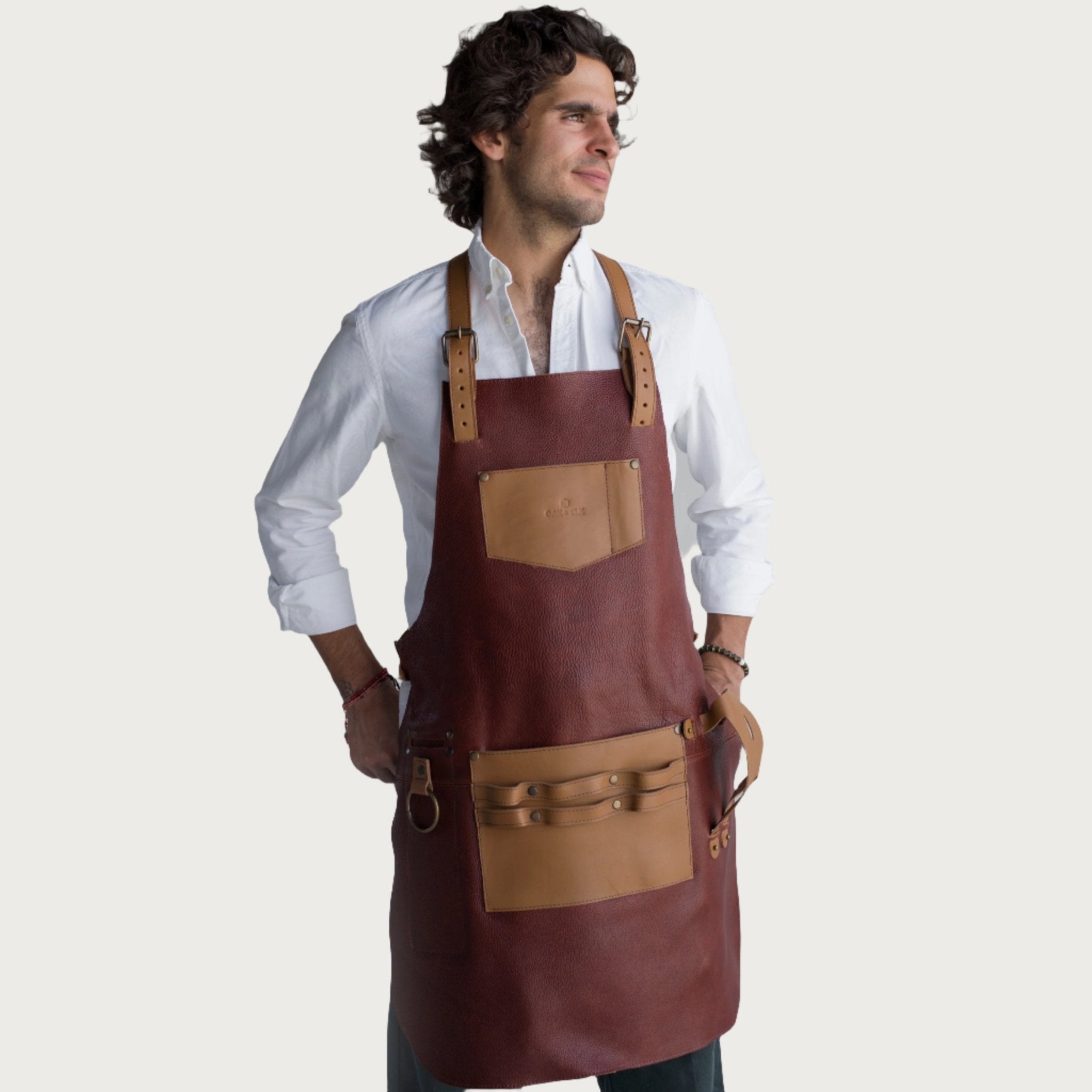 Full leather apron, adjustable straps, front chest pocket, tool loops, and rich texture, ideal for grilling, crafts, shop use