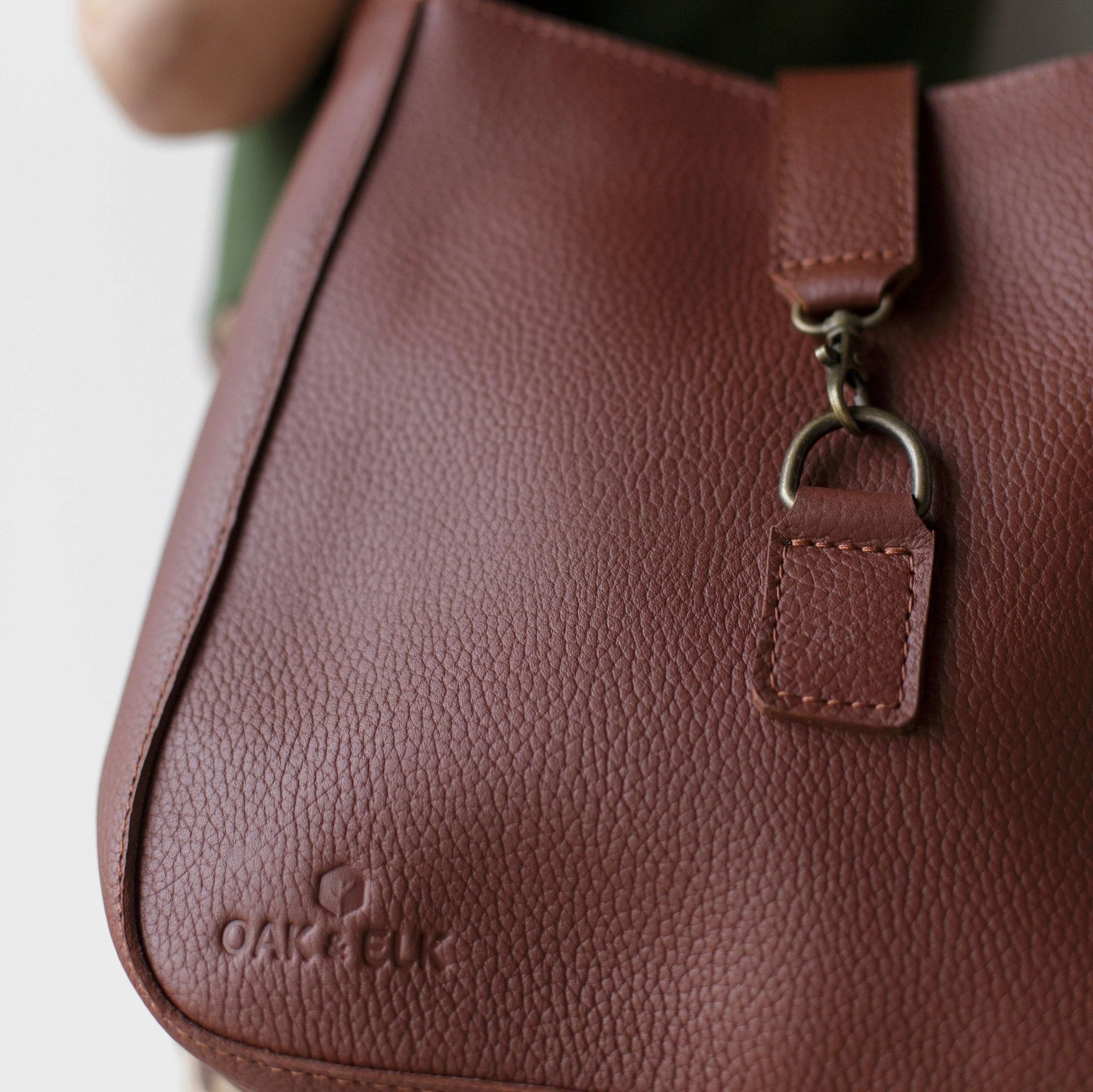 Full-grain leather shoulder bag with minimalist design, adjustable strap, interior pocket, soft structure, everyday essential