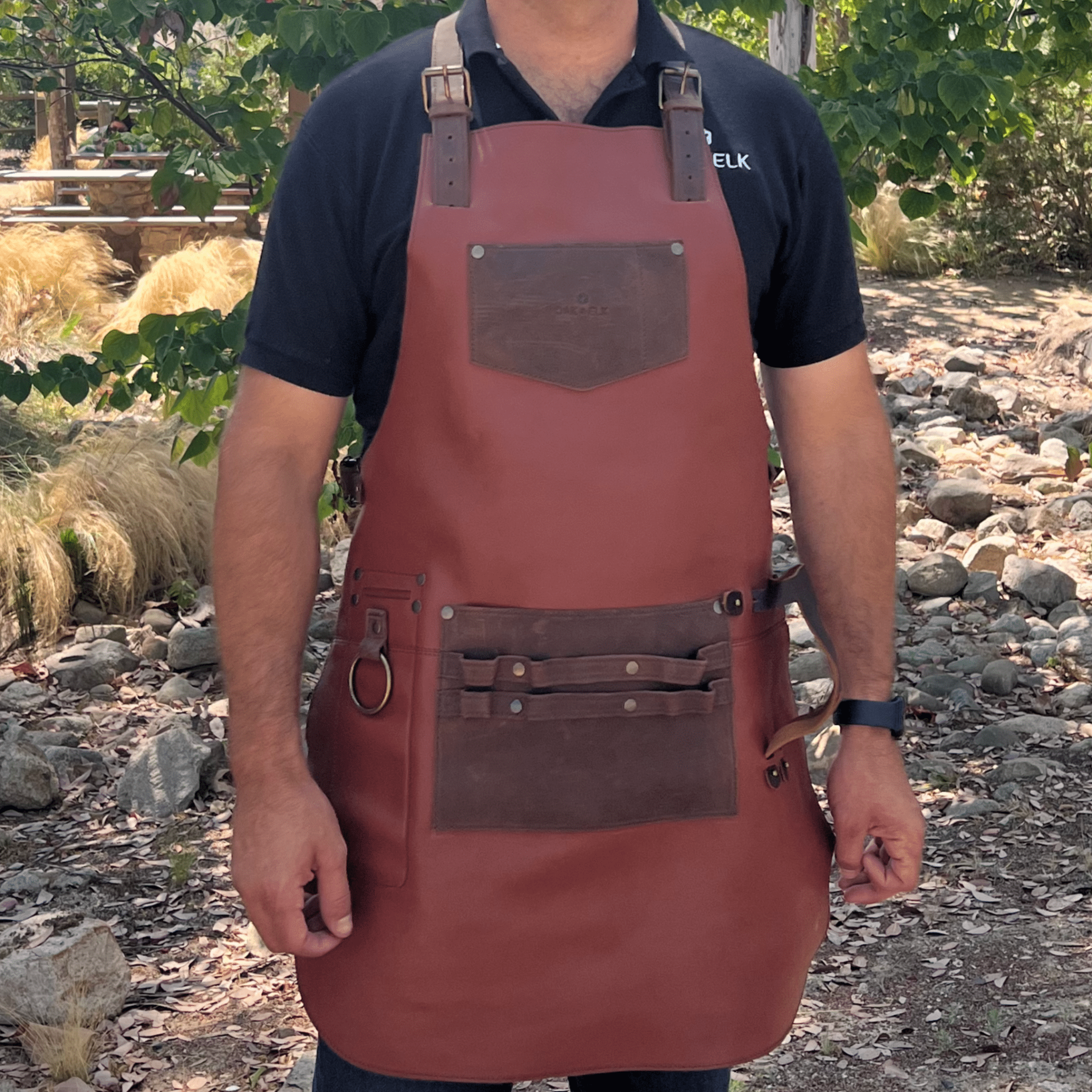 Full leather apron, adjustable straps, front chest pocket, tool loops, and rich texture, ideal for grilling, crafts, shop use